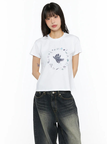 Graphic Meow Crop Tee CU530 White front close-up model torso showing circular ocean creature graphic print with shells starfish and coral details
