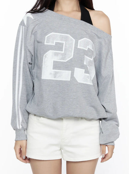 Graphic Off-Shoulder Sweatshirt CL527 Gray close-up front shot on model detail of distressed 23 graphic print white stripe sleeve and off-shoulder cut