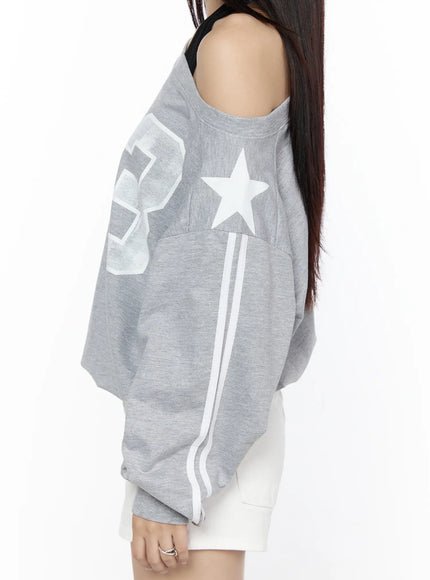 Graphic Off-Shoulder Sweatshirt CL527 Gray close-up side shot on model highlighting white star motif double sleeve stripes and open shoulder detail