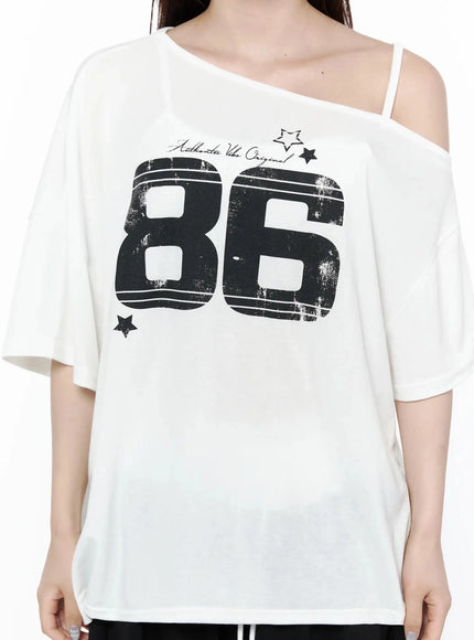 Graphic Off-Shoulder T-Shirt IL506 White close-up front detail on model, distressed 86 number graphic, Authentic Vibe Original script, star motifs, asymmetric shoulder strap