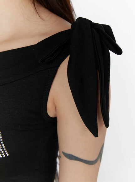 Graphic Off-Shoulder Top CL508 Black close-up detail shot shoulder bow-tie knot construction armhole cutout stretch knit fabric texture on model
