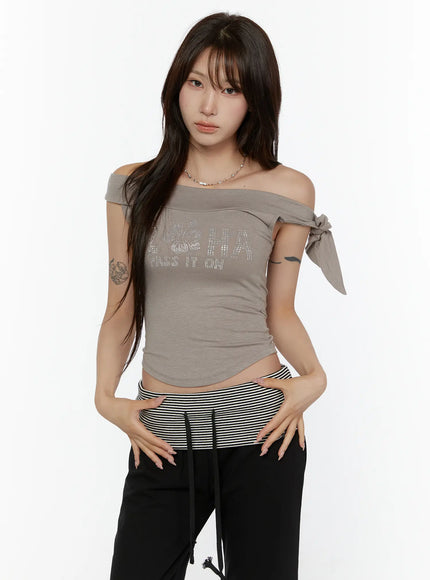 Graphic Off-Shoulder Top CL508 Khaki front cropped model shot off-shoulder neckline rhinestone ALOHA hibiscus graphic bow-tie detail ribbed stretch fabric