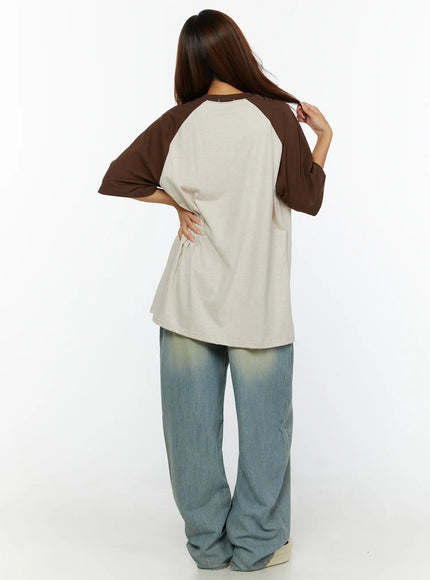 Graphic Oversided Tee CL515 Brown back view on model showing clean beige back panel with brown raglan sleeves and relaxed oversized silhouette
