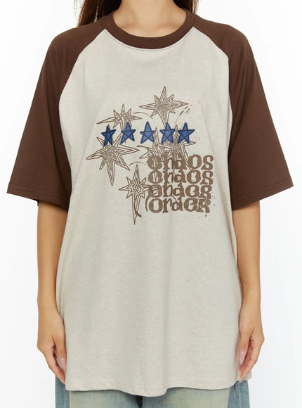 Graphic Oversided Tee CL515 Brown close-up front detail showing blue star embroidery chaos chaos chaos order retro graphic print on beige cotton body