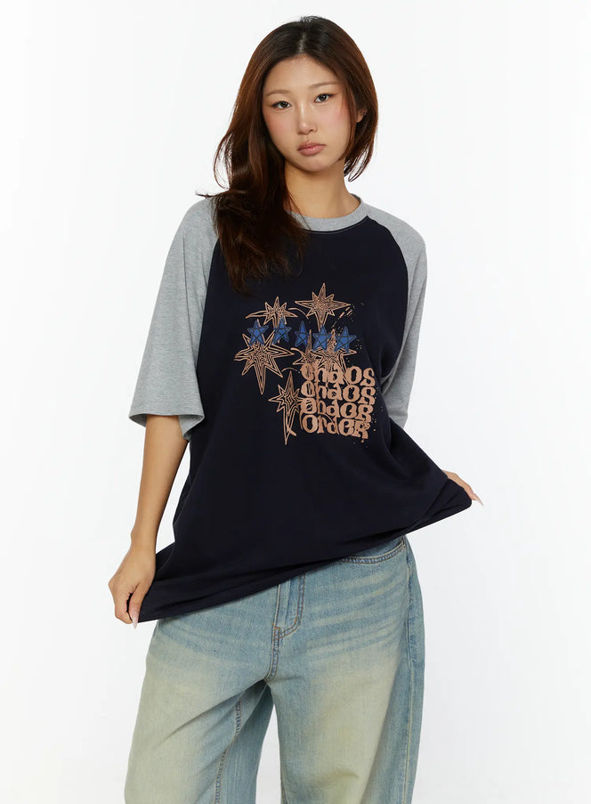 Graphic Oversided Tee CL515 Navy front view on model showing navy body with grey raglan sleeves and star chaos order graphic print on chest