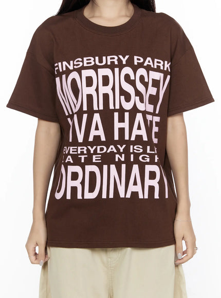 Graphic Oversized Layered Tee CL524 Brown close-up front shot on model without layered cuffs, bold pink Morrissey Ordinary graphic print, relaxed cotton fabric