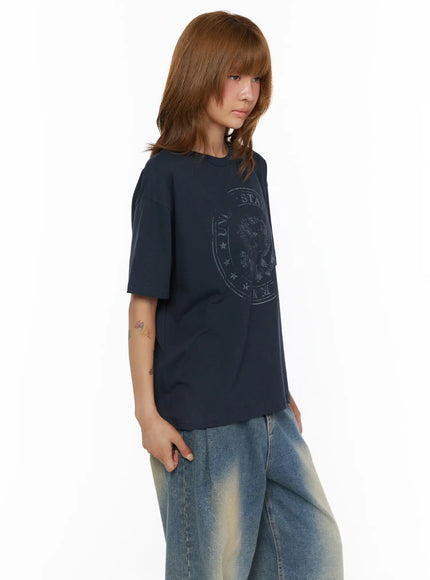 Graphic Oversized Tee CL503 Dark blue side shot on model showing eagle seal chest graphic and relaxed boxy silhouette with wide-leg denim
