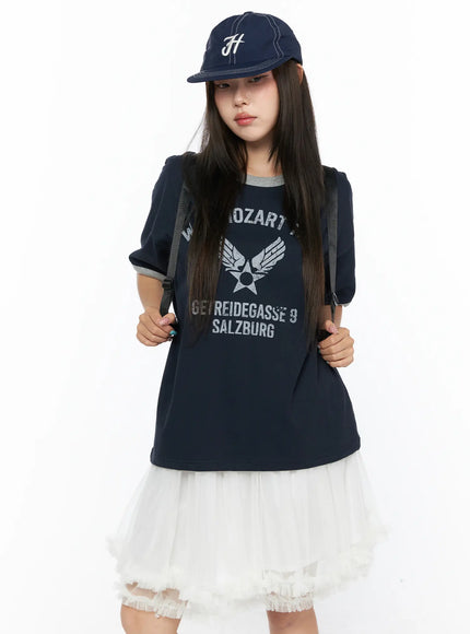 LEWKIN Graphic Oversized Tee CL517 Dark blue front view on model wearing cap and backpack, styled with white tulle skirt, vintage Mozart graphic print