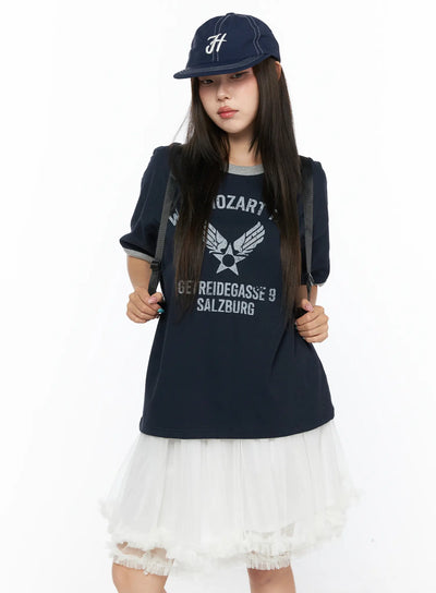 LEWKIN Graphic Oversized Tee CL517 Dark blue front view on model wearing cap and backpack, styled with white tulle skirt, vintage Mozart graphic print