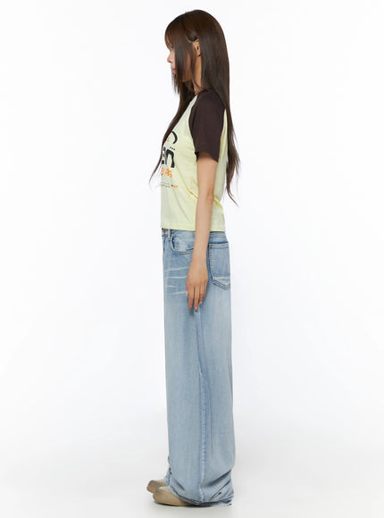 Graphic Print Color Block Tee IL523 Yellow full-body side shot on model showing slim cropped silhouette, dark brown raglan sleeve, light wash wide-leg jeans