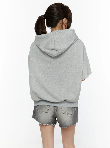 Graphic Print Short Sleeve Hooded Zip-Up CL507 Gray back view on model showing plain hood and banded hem styled with denim shorts standing straight