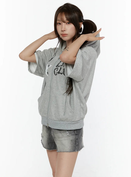 Graphic Print Short Sleeve Hooded Zip-Up CL507 Gray three-quarter side view model arms crossed behind neck styled with denim shorts