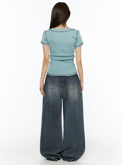 Graphic Print V-Neck Tee IL523 Light blue back model shot showing plain back contrast stitching hem detail with wide-leg jeans
