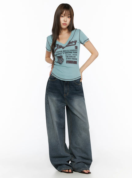 Graphic Print V-Neck Tee IL523 Light blue full-body front model shot hands in pockets styled with wide-leg faded denim