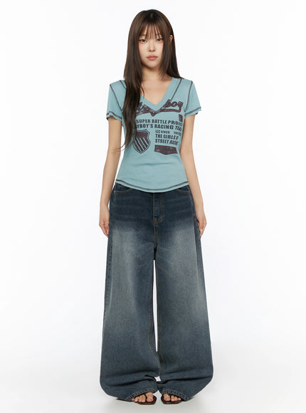 Graphic Print V-Neck Tee IL523 Light blue full-body front model shot standing straight arms at sides with wide-leg jeans