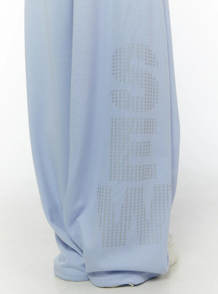 Graphic Print Wide Sweatpants CL507 light blue close-up detail of silver star letter graphic print along lower leg hem