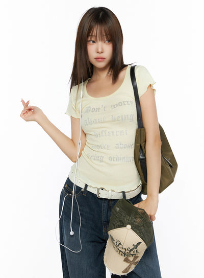 LEWKIN Graphic Scoop Neck Top IL523 Yellow front shot on model styled with jeans, bag, and earphones, rhinestone gothic letter print, flutter sleeves, S/M