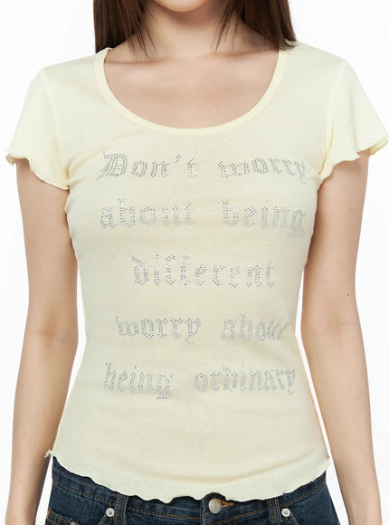 Graphic Scoop Neck Top IL523 Yellow close-up front detail shot on model showing silver rhinestone gothic script, scoop neckline, and lettuce-edge hem