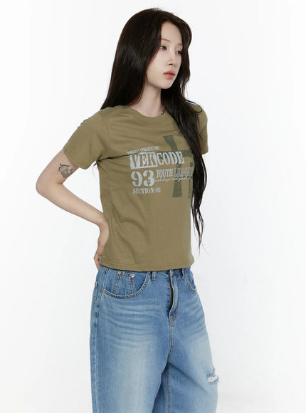 Graphic Semi-Crop T-Shirt IL522 Khaki three-quarter front shot on model showing tonal VEKCODE 93 graphic print on olive green cotton cropped tee