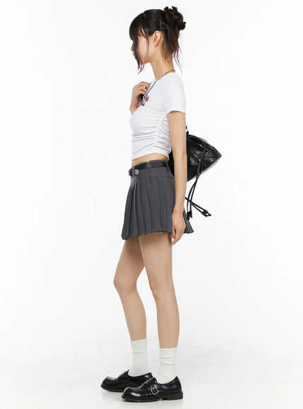 Graphic Shirred Crop Tee CU530 White three-quarter side view on model in ponytail hand on hip displaying horse graphic print and fitted ribbed ruched body