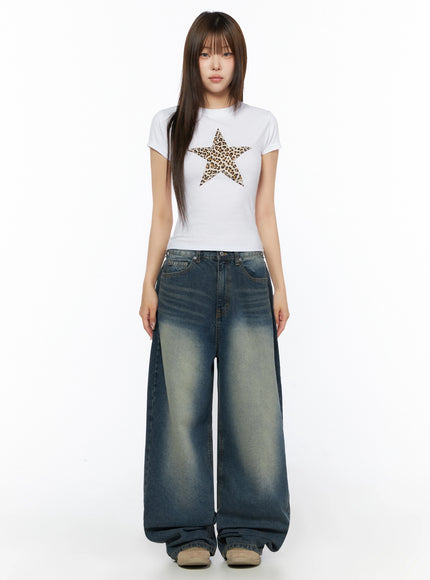 Graphic Short Sleeve T-Shirt IL523 White full-body front model shot standing straight showing leopard star graphic fitted crop tee with ultra wide-leg washed denim jeans
