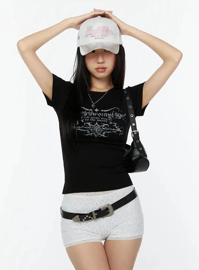 LEWKIN Graphic Short Sleeve Tee IU524 Black S/M front model shot styled with white lace shorts and cap, gothic calligraphy print