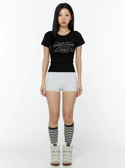 Graphic Short Sleeve Tee IU524 Black full-length front model shot styled with white lace shorts, striped knee socks and white wedge sneakers