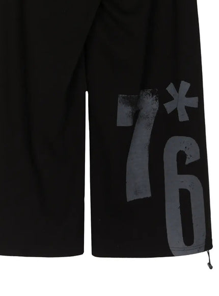 Graphic Sweatpants IL509 Black close-up detail of lower leg showing charcoal-on-black 7*6 graphic print contrast wide-leg opening and drawstring stopper at hem