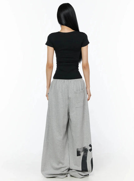 Graphic Sweatpants IL509 Gray back model shot full-length showing large 7*6 brushstroke graphic on lower legs back patch pocket and gathered elastic waistband