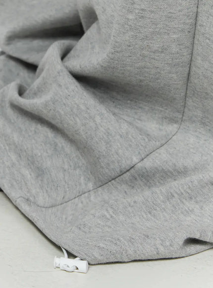 Graphic Sweatpants IL509 Gray close-up detail of hem and drawstring toggle showing heathered cotton fleece texture and voluminous pooled leg opening