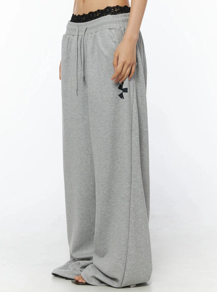 Graphic Sweatpants IL509 Gray side model shot cropped waist-down view showing lace bralette layering elastic waistband side pocket and wide-leg silhouette length