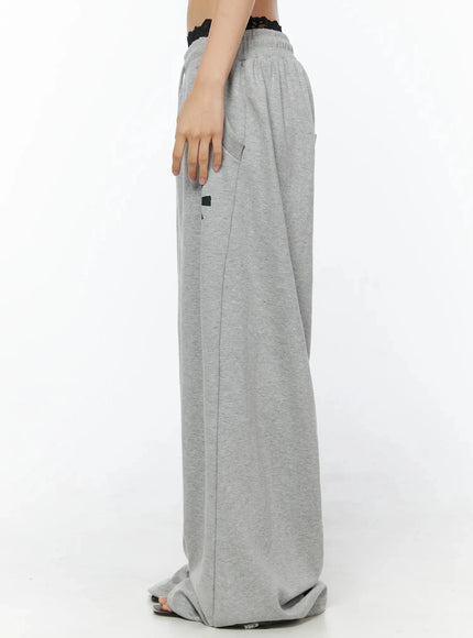 Graphic Sweatpants IL509 Gray side model shot waist-down showing side pocket detail lace waistband overlay and full wide-leg drape pooling at hem