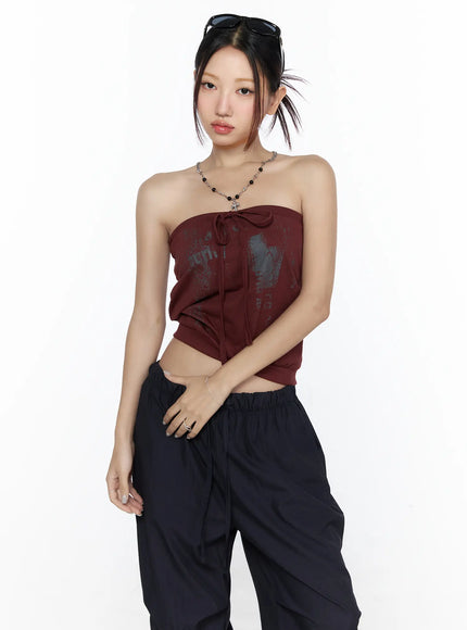 LEWKIN Graphic Tube Top CL527 Dark red front model shot cropped three-quarter pose with graphic print tie detail styled with chain necklace and black cargo pants