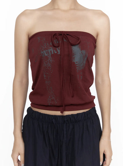 Graphic Tube Top CL527 Dark red close-up front detail shot showing graphic print center drawstring tie bow and ribbed waistband on model