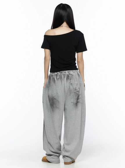 Graphic Wide Leg Sweatpants CL527 Gray back full-length shot on model in black off-shoulder top showing elastic waistband back pocket and wide leg hem