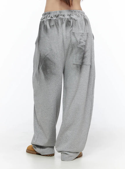 Graphic Wide Leg Sweatpants CL527 Gray back shot on model showing elastic waistband back patch pocket and wide-leg fleece fabric silhouette