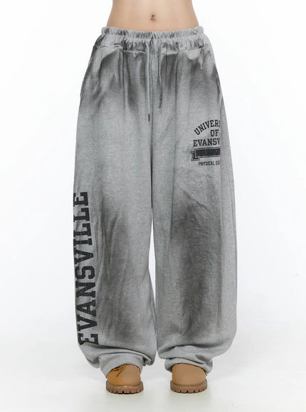 Graphic Wide Leg Sweatpants CL527 Gray front shot on model showing elastic drawstring waistband and Evansville collegiate graphic print on wide leg