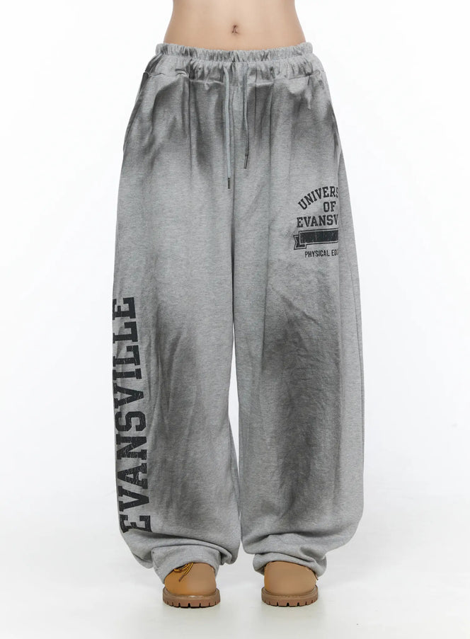 Graphic Wide Leg Sweatpants CL527 Gray front shot on model showing elastic drawstring waistband and Evansville collegiate graphic print on wide leg
