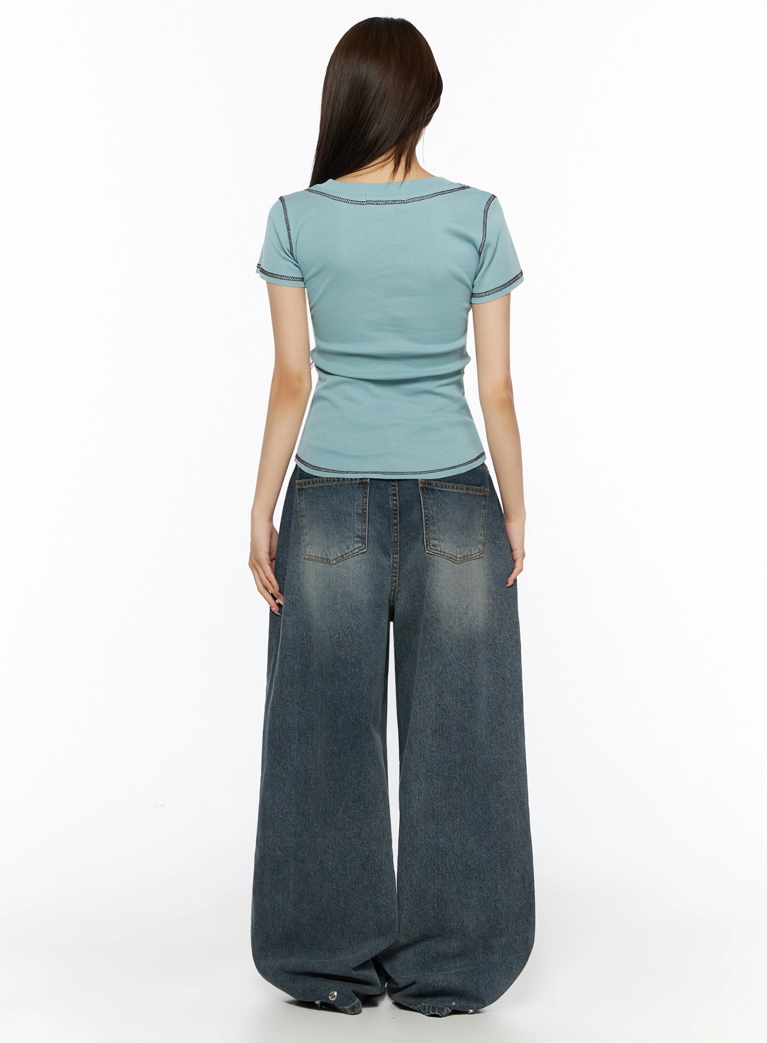 Greer Vintage Wash Baggy Jeans IL523 Dark blue back view on model with blue tee showing rear pockets contrast stitching and snap hem