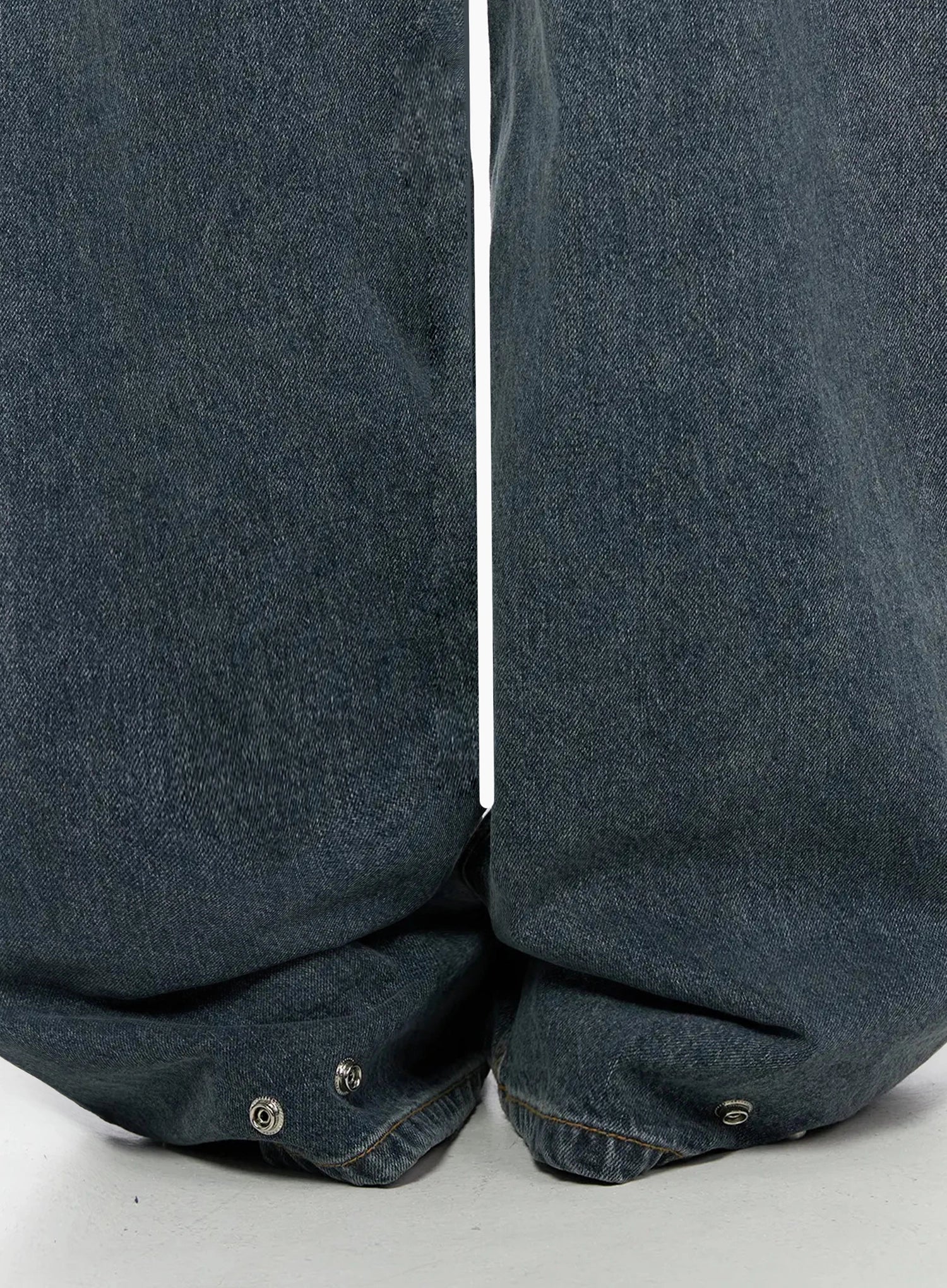 Greer Vintage Wash Baggy Jeans IL523 Dark blue close-up detail of hem showing silver snap buttons and pooling denim at ankles