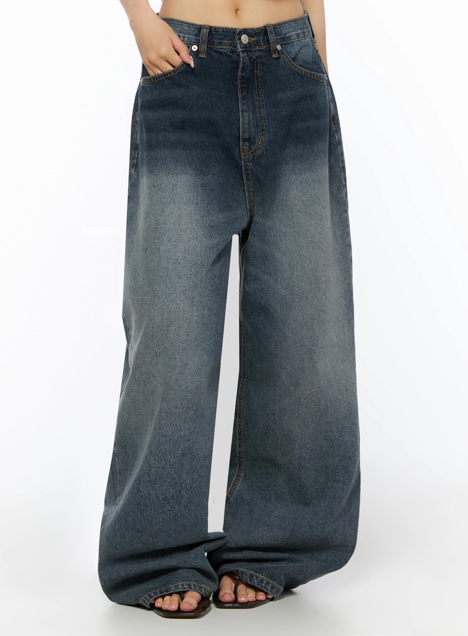 Greer Vintage Wash Baggy Jeans IL523 Dark blue front cropped torso shot with hand in pocket showing waistband and whiskered wash detail