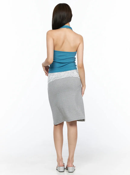 Halter Crop Top CL517 Blue back view on model showing open back halter tie neck and exposed spine, paired with grey striped skirt