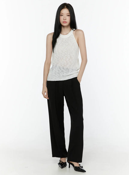 Halter Knit Top IL506 White front full-body shot on model standing upright styled with black wide-leg trousers and slingback heels semi-sheer knit