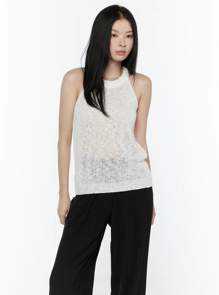 Halter Knit Top IL506 White front crop shot on model hands on hips highlighting halter neckline open knit semi-sheer texture and ribbed hem detail