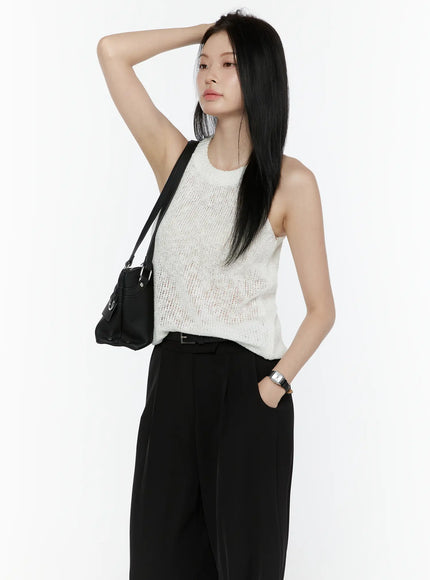 LEWKIN Halter Knit Top IL506 White side shot on model arm raised wearing black wide-leg trousers and crossbody bag semi-sheer open knit texture