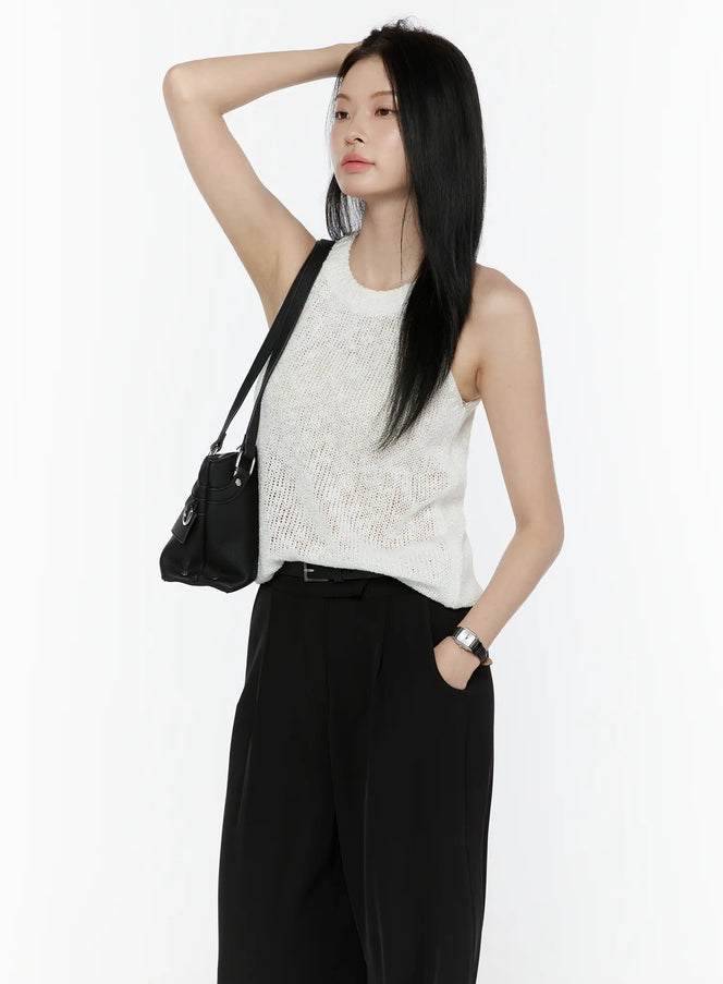 LEWKIN Halter Knit Top IL506 White side shot on model arm raised wearing black wide-leg trousers and crossbody bag semi-sheer open knit texture