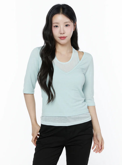 Halter Layered Three-Quarter Sleeve Top IU525 Mint front shot on model with wavy hair facing forward showing layered halter neckline and ribbed hem with black trousers
