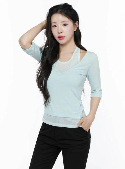 Halter Layered Three-Quarter Sleeve Top IU525 Mint front half-body shot on model hand in hair showing V-neck sheer panel halter strap and ribbed waist detail