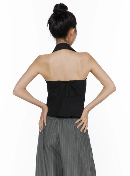 Halter Sleeveless Shirt CL510 Black back close-up on model hands on hips, open back halter design, gathered back panel, cropped silhouette detail