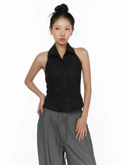 Halter Sleeveless Shirt CL510 Black front shot on model without accessories, button-down halter collar detail, hands on hips, cropped silhouette